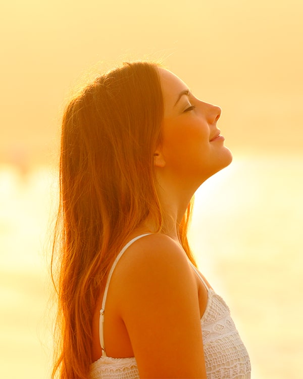 Woman standing in sun with a healthy mind