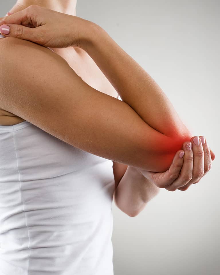 Woman holding her elbow having joint pain